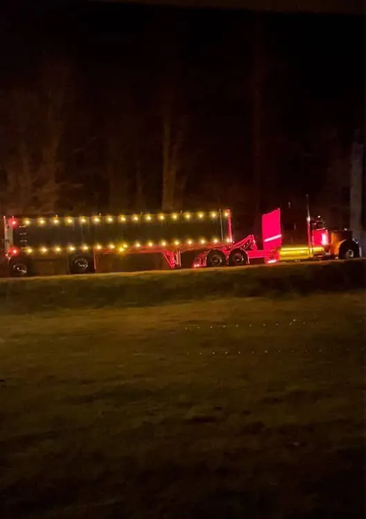 Mullins Trucking step deck trailer parked at night